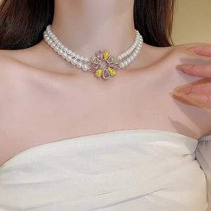 Elegant double-layer pearl necklace with a vibrant purple and yellow crystal flower pendant
