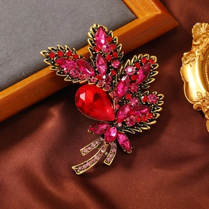 Vintage gold orchid brooch with large teardrop ruby and pink crystal leaf detailing
