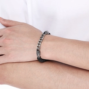 Detail of beaded bracelet featuring silver Buddha heads and black lava stone beads on wrist