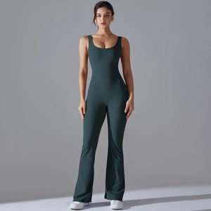 Detail of dark green one-piece yoga jumpsuit with flare leg and sleeveless backless design