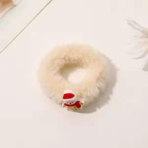 Close-up of fluffy white Christmas scrunchie with a cute small snowman charm detail