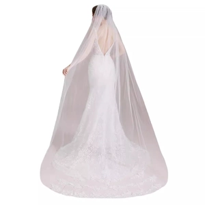 White mermaid bridal gown with V-neck, open back, and long lace embroidered train