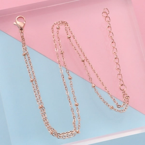 Detail of rose gold double layer bead chain with lobster clasp and extension links