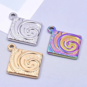 Detailed view of square steel pendants with spiral floral relief in gold, silver and rainbow