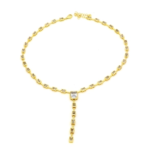 Close-up of golden Y-necklace featuring rectangular clear cubic zirconia stones