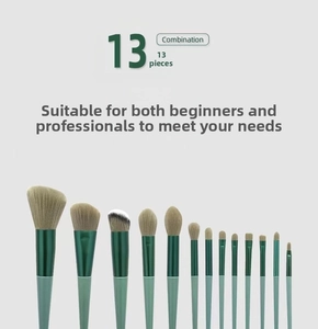 Macro shot of 13 professional makeup brushes with grey fiber bristles and emerald green handles