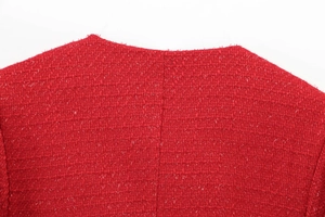 Macro detail of the round neckline and back stitching on a red tweed leisure jacket