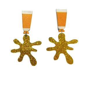 Creative acrylic paint tube earrings with vibrant orange tubes and golden glitter splashes