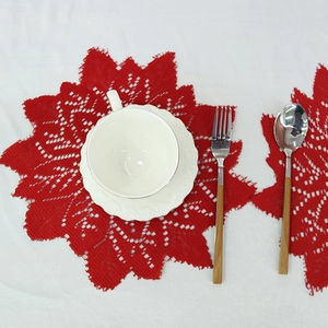 Red Christmas lace placemat with round floral pattern and scalloped edges for festive table decor