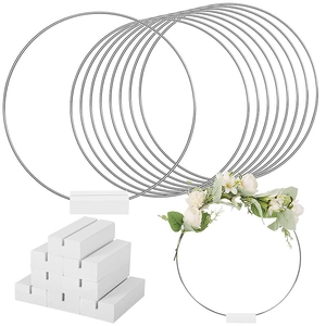 Detail view of DIY wedding centerpieces featuring gold metal hoops and white wooden bases