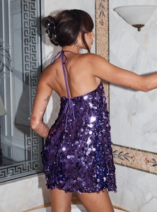 Detail of purple sequin halter dress showing the backless design and sparkling texture