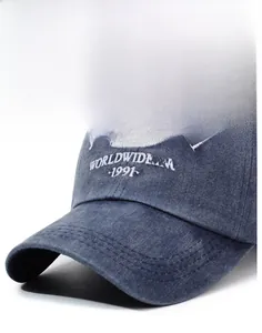 Detailed close-up of white 3D embroidery and washed denim texture on a vintage baseball cap