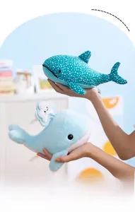 Detail of plush whale toys featuring blue polka dots and a cute cloud accessory decor