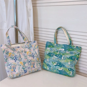 Détail de sacs en coton à fleurs et lapins avec étiquettes 'simple wish' sur fond bois