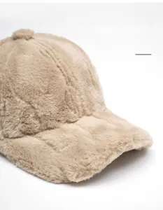 Detailed view of beige faux fur baseball cap with wide foldable brim and soft plush texture