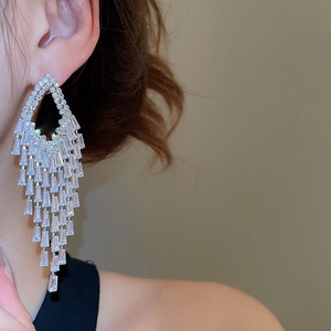 Detailed view of silver diamond-encrusted tassel earrings with sparkling zircon fringe