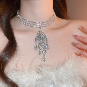 Detail of multi-layer silver choker with sparkling rhinestones, pearls and fringe pendant