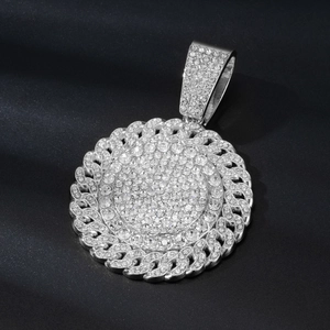 Detail of silver paved crystal round pendant on black silk with cuban chain