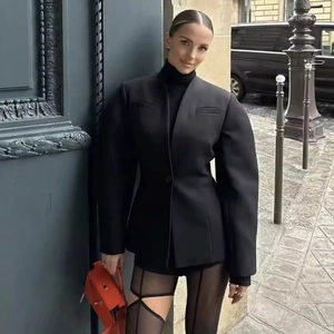 Chic black V-neck puff sleeve blazer coat styled with an orange leather handbag