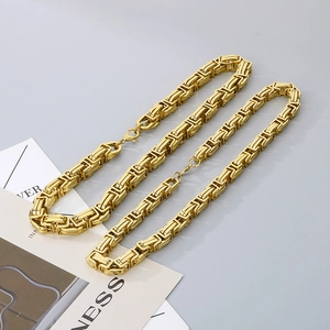 Detailed close-up of golden Byzantine square link chain with secure lobster clasp closure