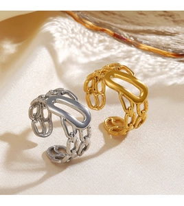 Detail view of 18K gold and silver chunky chain rings with oval plates on satin