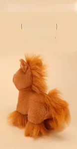 Close-up of soft brown plush horse toy with fluffy dark brown mane and tail detail