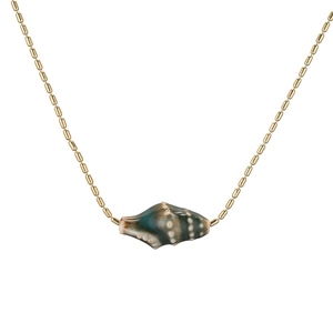 Detail shot of a golden beaded chain necklace with a green conch shell pendant