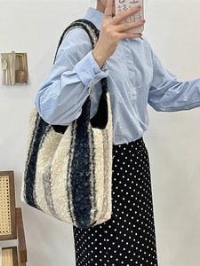 Large black and white striped plush tote bag for women shown in a mirror selfie