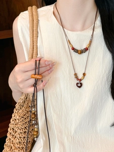 Close-up of coconut shell wood beads and heart pendant necklace in ethnic style