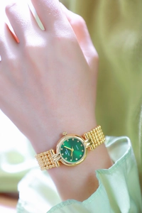 Wrist shot of BS Bee Sister gold quartz watch with green dial and crystal markers