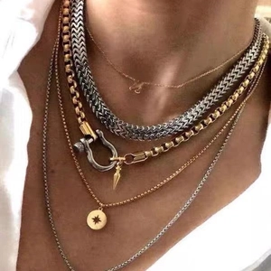 Layered gold and silver chain necklace set with horseshoe clasp and star pendant