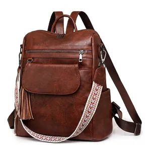 Vintage brown PU leather backpack for women with woven strap and tassel details