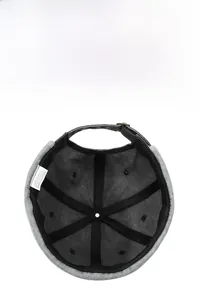 Detail view of cotton docker cap interior showing six-panel stitching and metal buckle