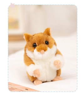 Close-up of a realistic plush hamster doll with brown and white fur and cute bead eyes