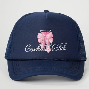 Navy mesh trucker hat featuring Cocktail Club embroidery and a pink bow detail