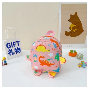 Detail of pink toddler backpack showing cute cartoon dinosaur prints and 3D fin design