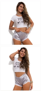 Detail of silver metallic athletic shorts paired with white graphic cropped t-shirt