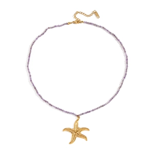 Close-up of ocean-style beaded necklace with purple crystals and golden starfish pendant