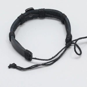 Detailed view of black leather woven bracelet with adjustable cord and metal fastener