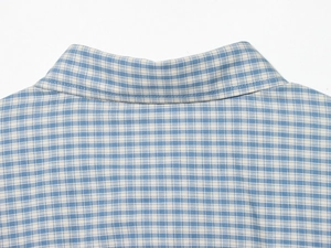 Detail of blue and white plaid shirt collar with cotton texture and stitching