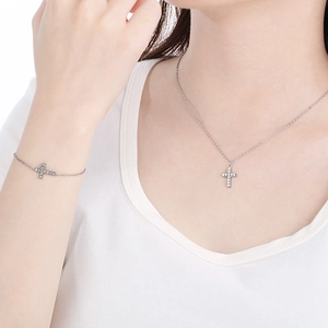 Detailed view of silver stainless steel cross jewelry set with sparkling crystals