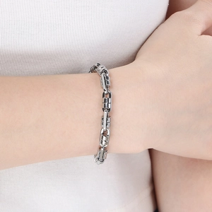 Detailed view of silver Byzantine link chain bracelet worn on wrist for size reference