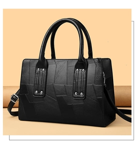 Detail showing high-quality black crocodile texture leather with silver metal hardware