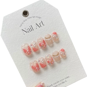 Handmade mermaid pearl press-on nails in soft pink peach with 3D crystal accents