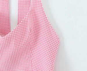 Detail shot of pink and white checkered fabric with visible stitching and texture