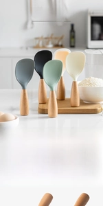 Close-up of silicone rice spoons with wooden handles and non-stick textured surfaces