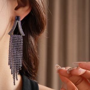 Detailed close-up of purple zircon tassel earrings with square main stone and long fringes