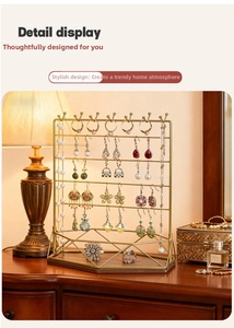 Macro detail of multi-tier gold iron jewelry rack with hooks for earring and necklace display