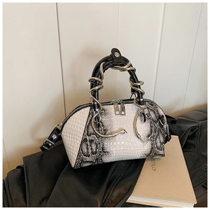 Detail view of white and gray snakeskin pattern texture on faux leather handbag