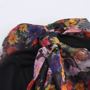 Women's black casual top featuring floral organza puff sleeves and a chic bow neckline